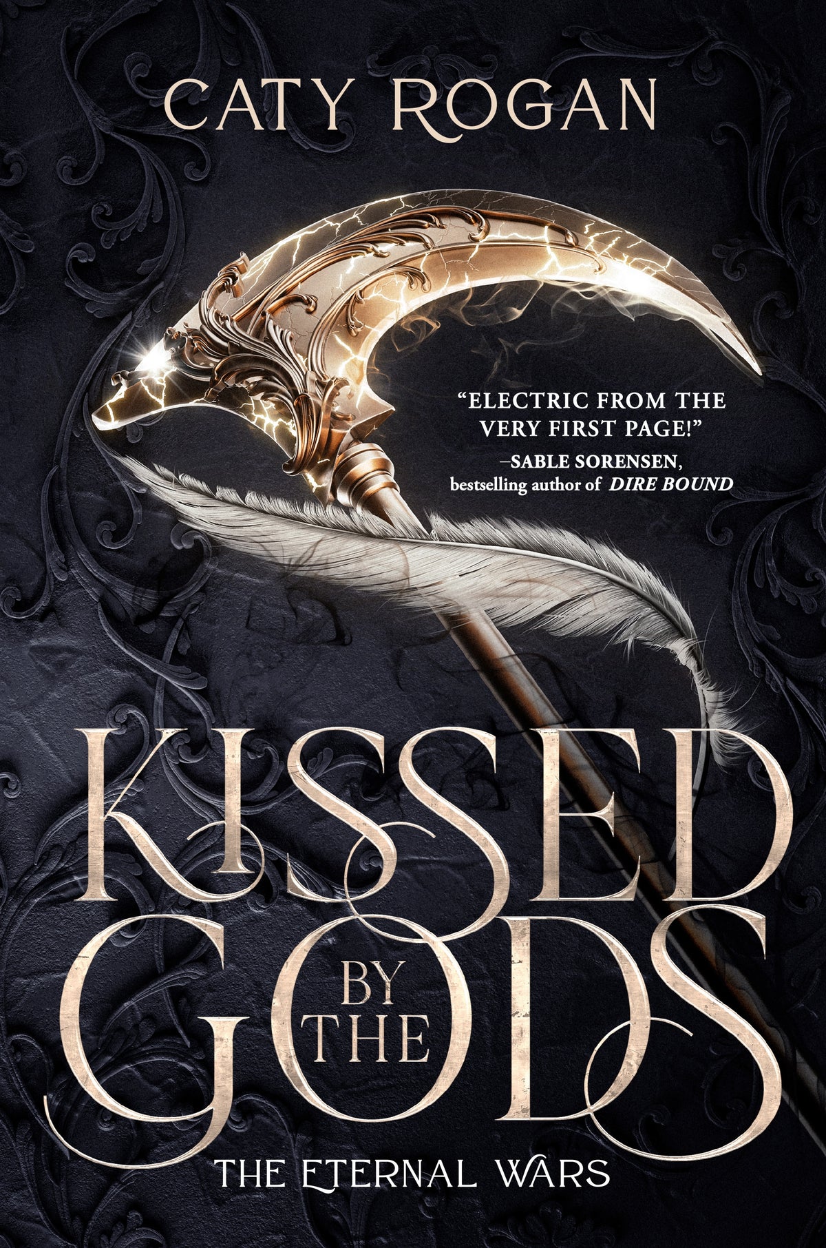 Book cover of 'Kissed by the Gods' by Caty Rogan with a decorative weapon and dark background.