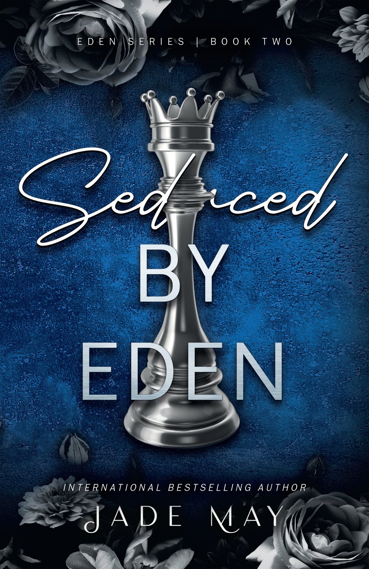 Book cover of 'Seduced by Eden' with a silver chess piece and roses on a blue background.